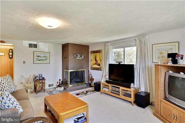 carpeted living room featuring a fireplace