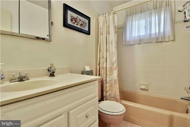 full bathroom featuring tile patterned flooring, shower / bath combination with curtain, vanity, and toilet