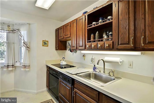 kitchen with dark brown cabinetry, black appliances, and sink