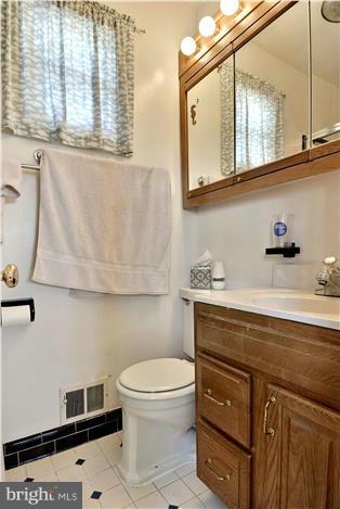 bathroom featuring tile patterned floors, vanity, and toilet