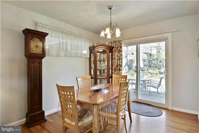 dining area featuring a notable chandelier and hardwood / wood-style flooring