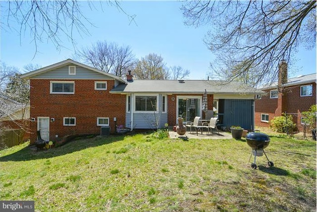 rear view of house featuring a patio and a lawn