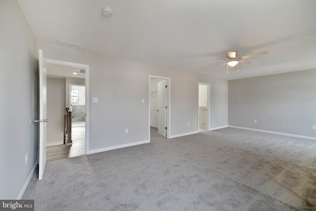 spare room with ceiling fan and carpet