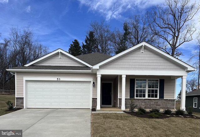 view of front of house featuring a porch and a garage