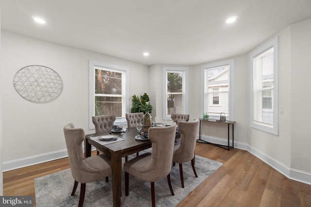 dining space with wood-type flooring