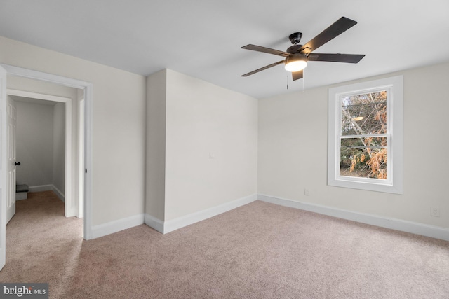 spare room with light colored carpet and ceiling fan