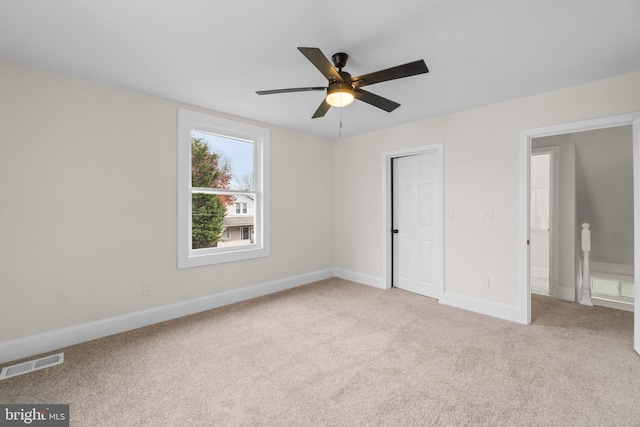 unfurnished bedroom with ceiling fan and light colored carpet