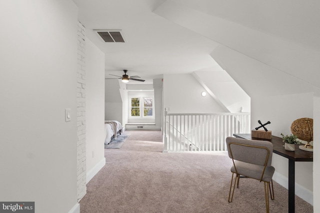 office area featuring light colored carpet, vaulted ceiling, and ceiling fan