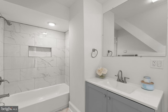 bathroom with vanity and tiled shower / bath combo