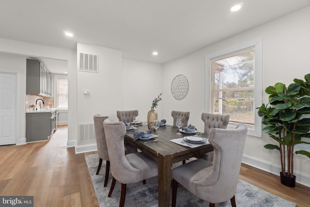 dining area featuring wood-type flooring and sink