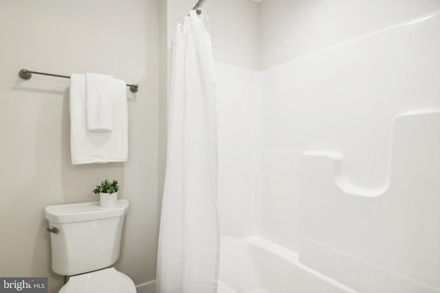 bathroom featuring toilet and walk in shower