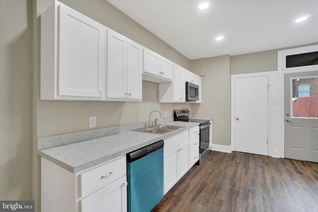 kitchen with sink, white cabinetry, stainless steel appliances, and dark wood-type flooring