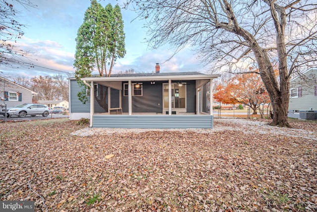 415 Tamara Cir, Newark, DE 19711 - rear view of house featuring a sunroom, a chimney, and central AC