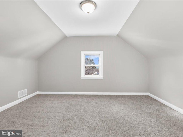 bonus room with carpet and lofted ceiling