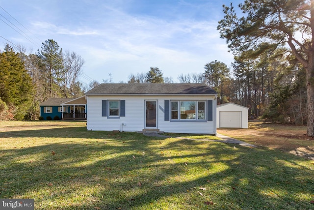 ranch-style house featuring a garage, an outbuilding, and a front yard