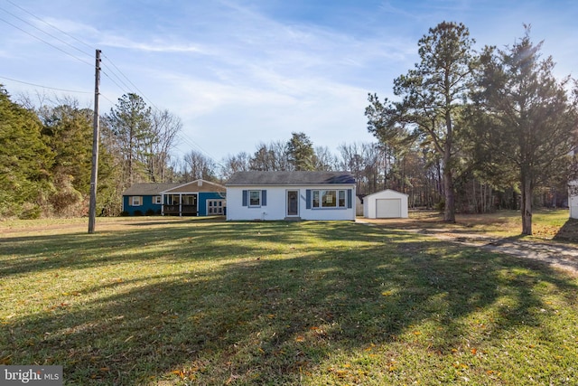 ranch-style house with an outbuilding, a front yard, and a garage