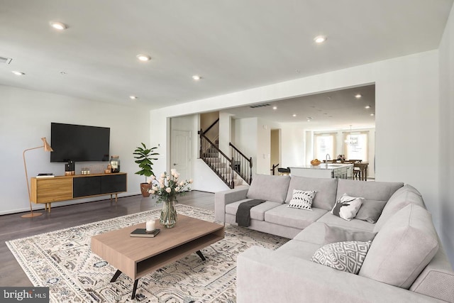 living room featuring hardwood / wood-style floors and sink