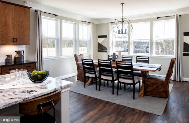 dining area with crown molding, plenty of natural light, and dark hardwood / wood-style floors