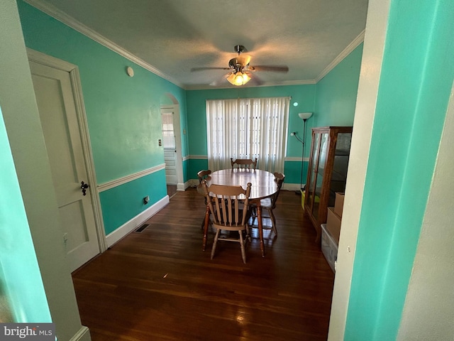 dining space featuring ceiling fan, crown molding, and dark hardwood / wood-style floors