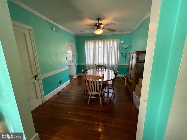 dining area featuring dark hardwood / wood-style floors, ceiling fan, and ornamental molding