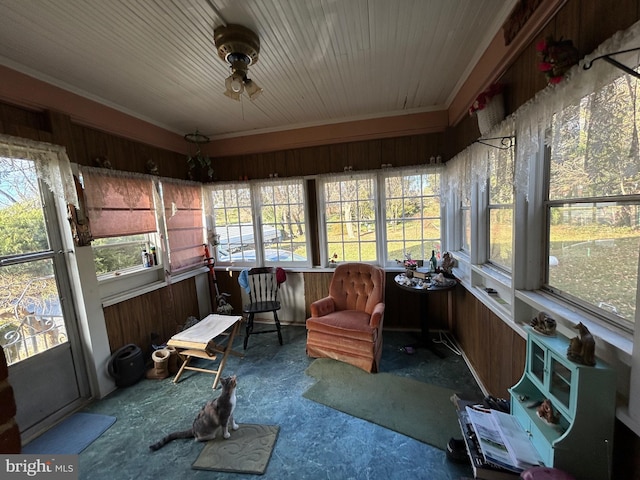 sunroom / solarium featuring ceiling fan and plenty of natural light