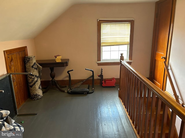 bonus room with hardwood / wood-style floors and vaulted ceiling