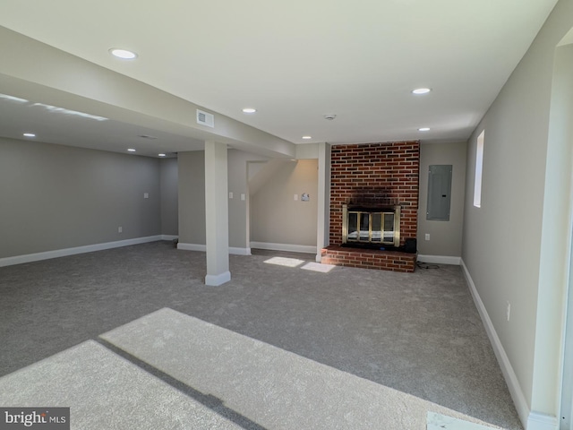 unfurnished living room featuring a fireplace, carpet floors, and electric panel