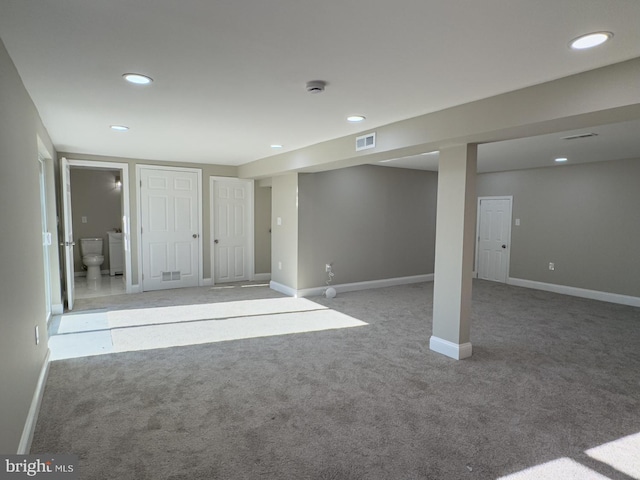 basement featuring light colored carpet