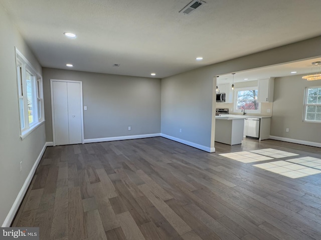 unfurnished living room with wood-type flooring