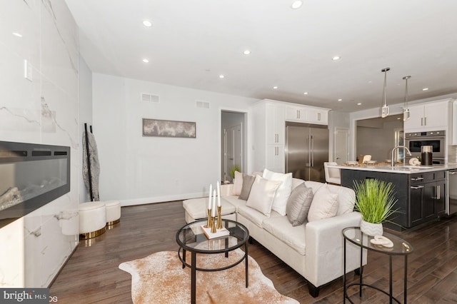 2418 Taney Rd, Baltimore, MD 21209 - living room featuring dark wood-style floors, recessed lighting, and baseboards