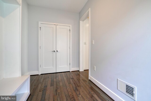 2418 Taney Rd, Baltimore, MD 21209 - unfurnished bedroom featuring dark wood-style flooring, baseboards, and a closet