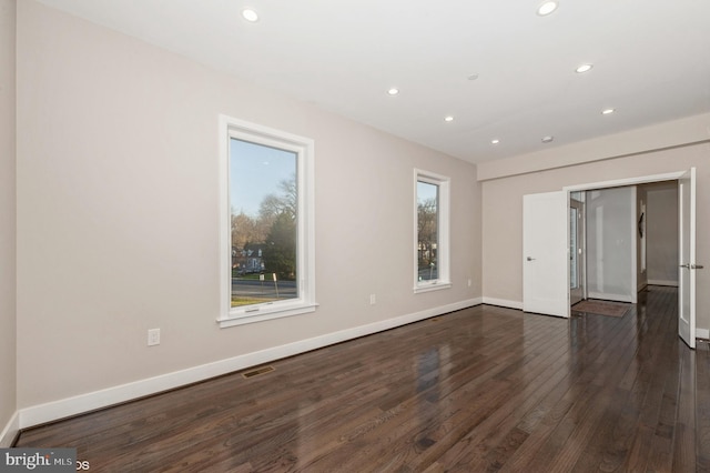 empty room featuring dark wood-type flooring