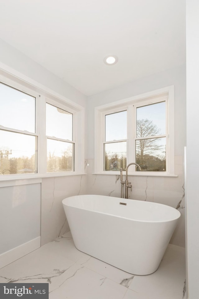 bathroom with a tub to relax in