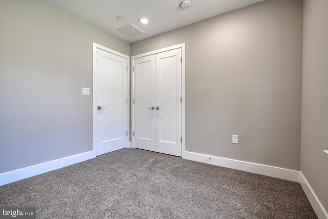 unfurnished bedroom featuring carpet floors and a closet