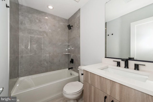 full bathroom with vanity, toilet, and tiled shower / bath