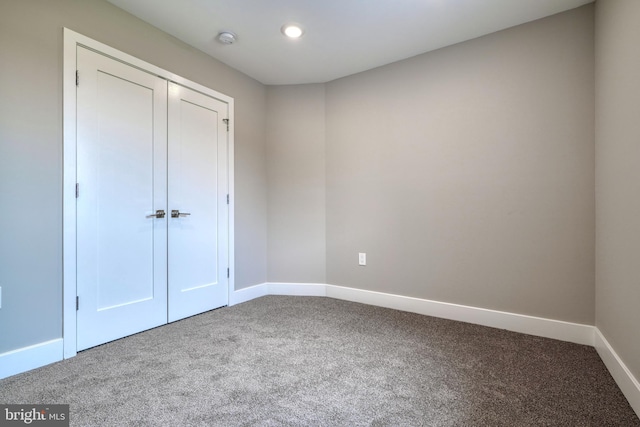 unfurnished bedroom with carpet and a closet