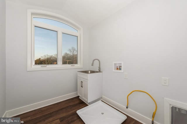 laundry area with hookup for a washing machine, sink, cabinets, and dark hardwood / wood-style floors