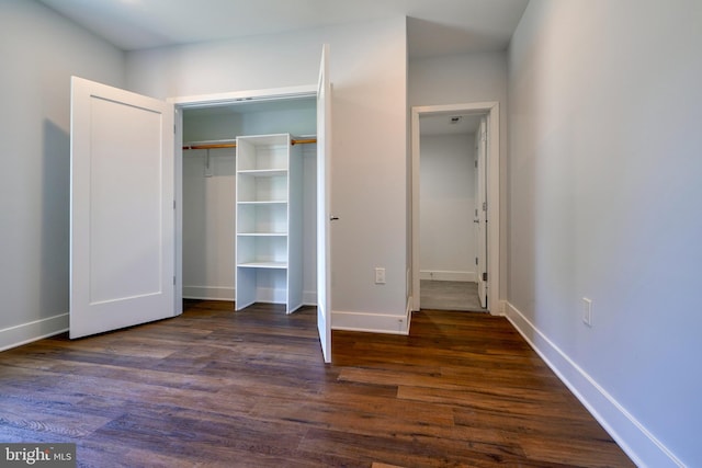 unfurnished bedroom featuring dark hardwood / wood-style flooring