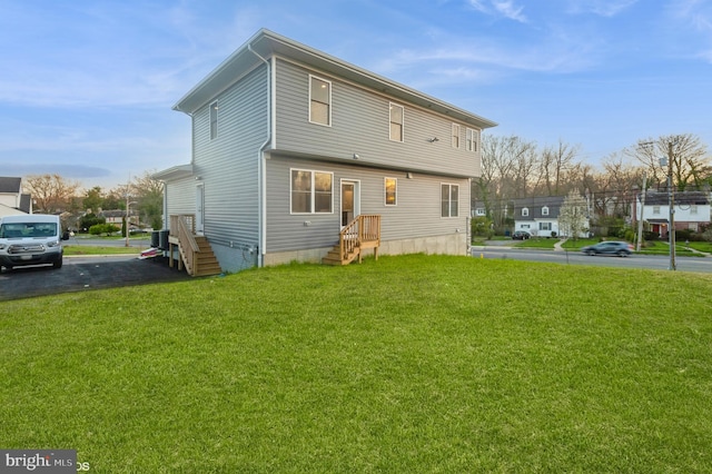 back of house with a lawn