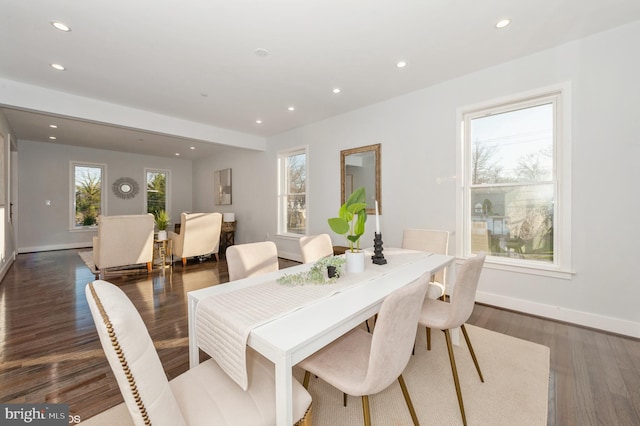 dining area with a healthy amount of sunlight and dark hardwood / wood-style flooring