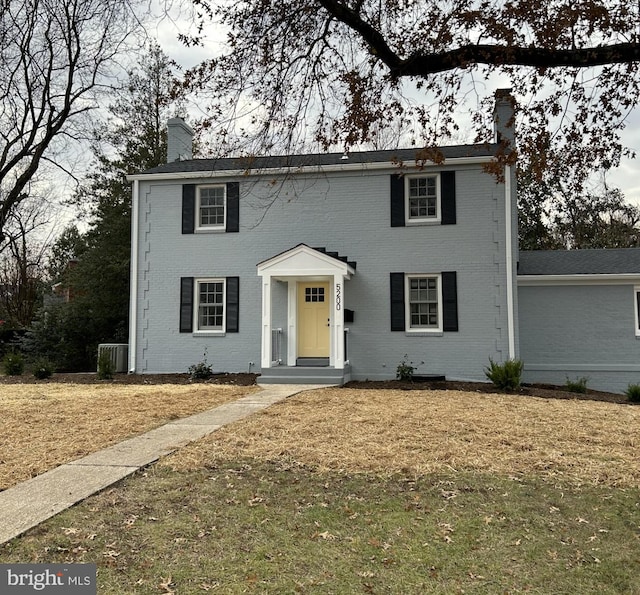 colonial-style house with a front yard