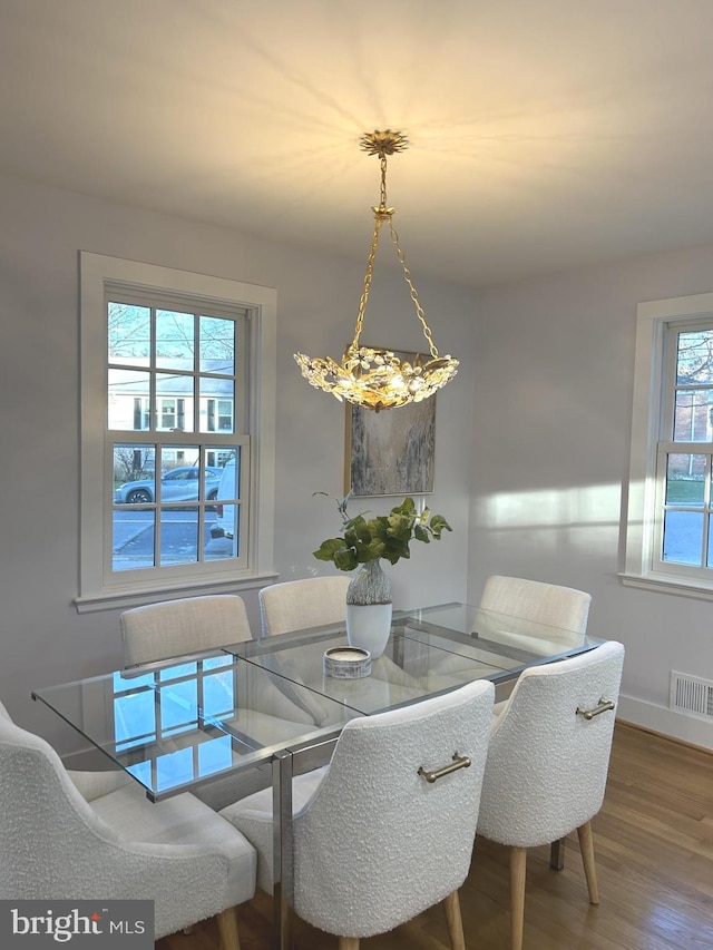 dining space featuring wood-type flooring