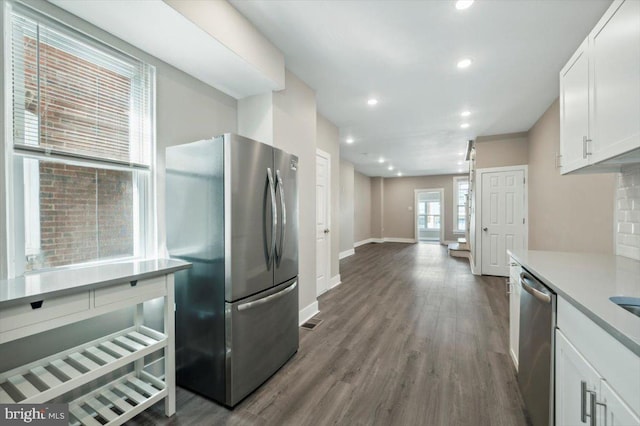 kitchen featuring white cabinets, wood-type flooring, and stainless steel appliances