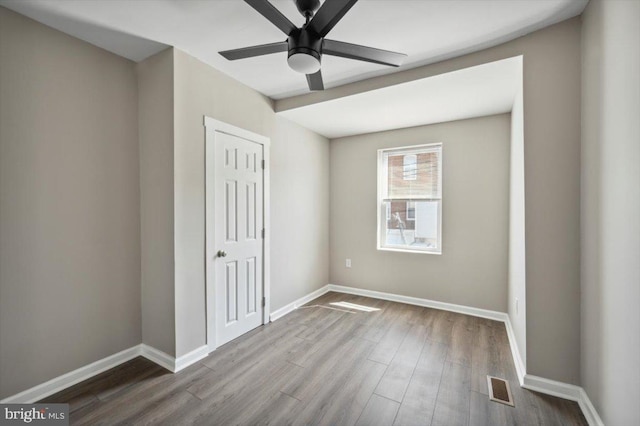 unfurnished bedroom featuring hardwood / wood-style floors and ceiling fan