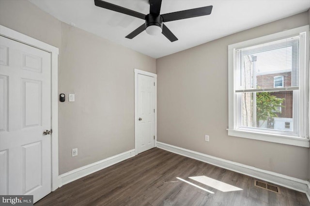 unfurnished bedroom with dark hardwood / wood-style flooring and ceiling fan