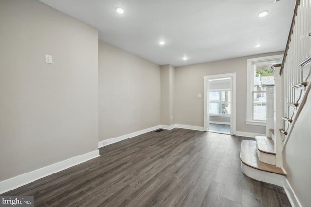 unfurnished living room with dark wood-type flooring