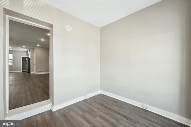 unfurnished room with dark hardwood / wood-style floors