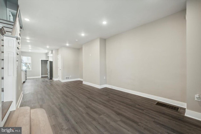 unfurnished living room featuring dark wood-type flooring