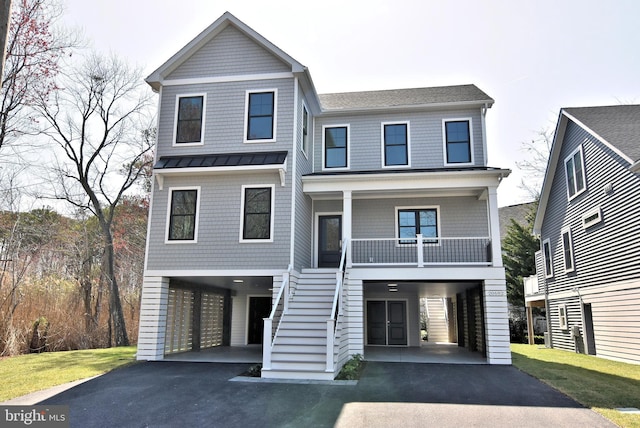 20682 Maple St, Rehoboth Beach, DE 19971 - beach home featuring a carport, asphalt driveway, stairs, and covered porch