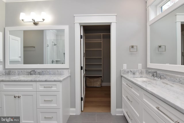 20682 Maple St, Rehoboth Beach, DE 19971 - bathroom featuring vanity, tile patterned flooring, a shower, and a spacious closet